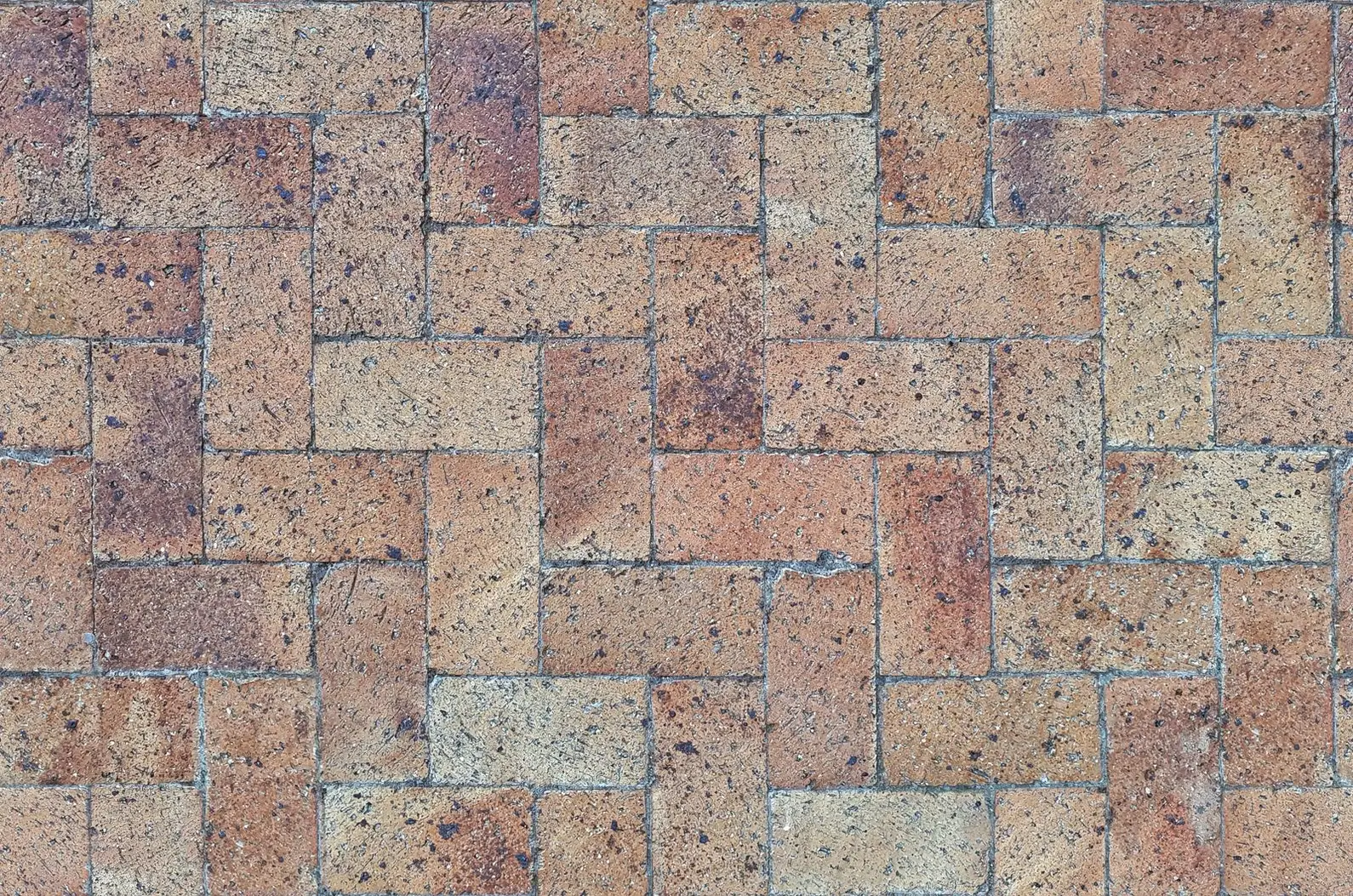 Close-up of a herringbone brick pattern with tight, even joints