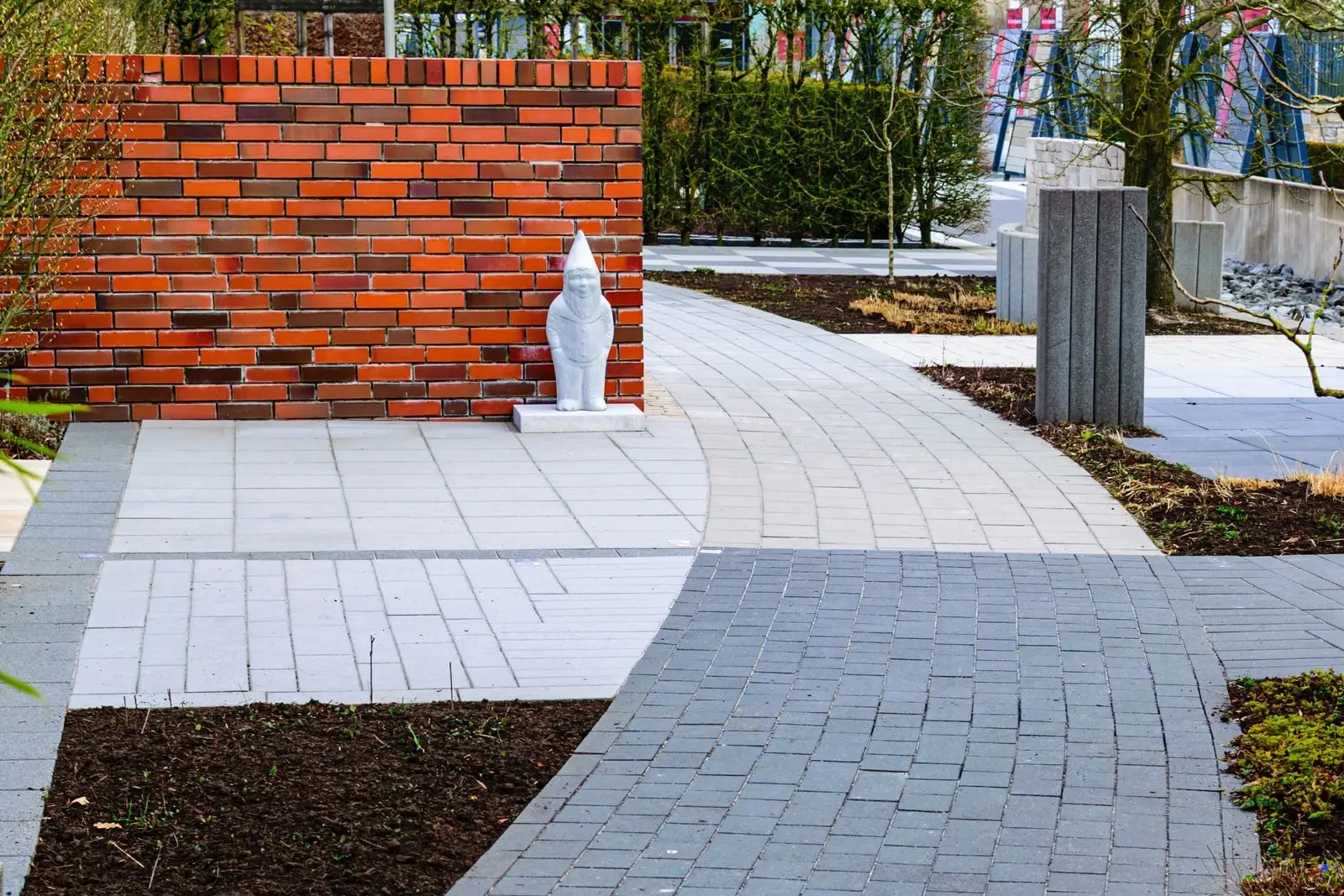 Paved walkway curving alongside a planted border