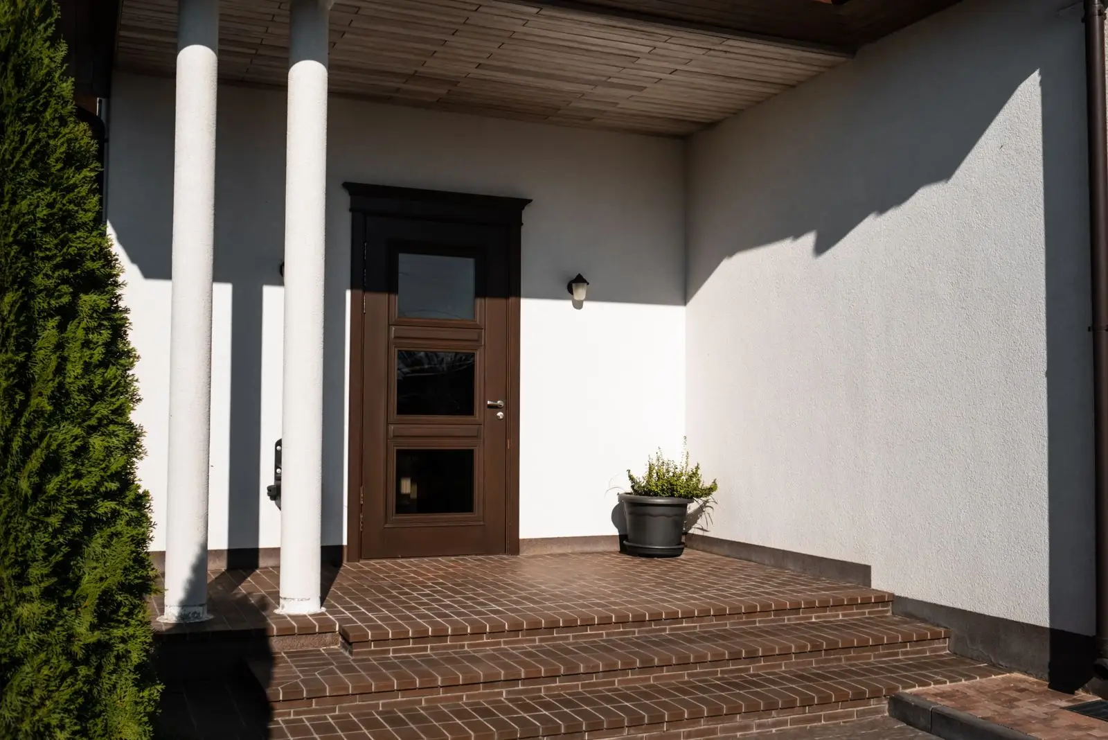 Rebuilt covered porch with brick steps and painted columns