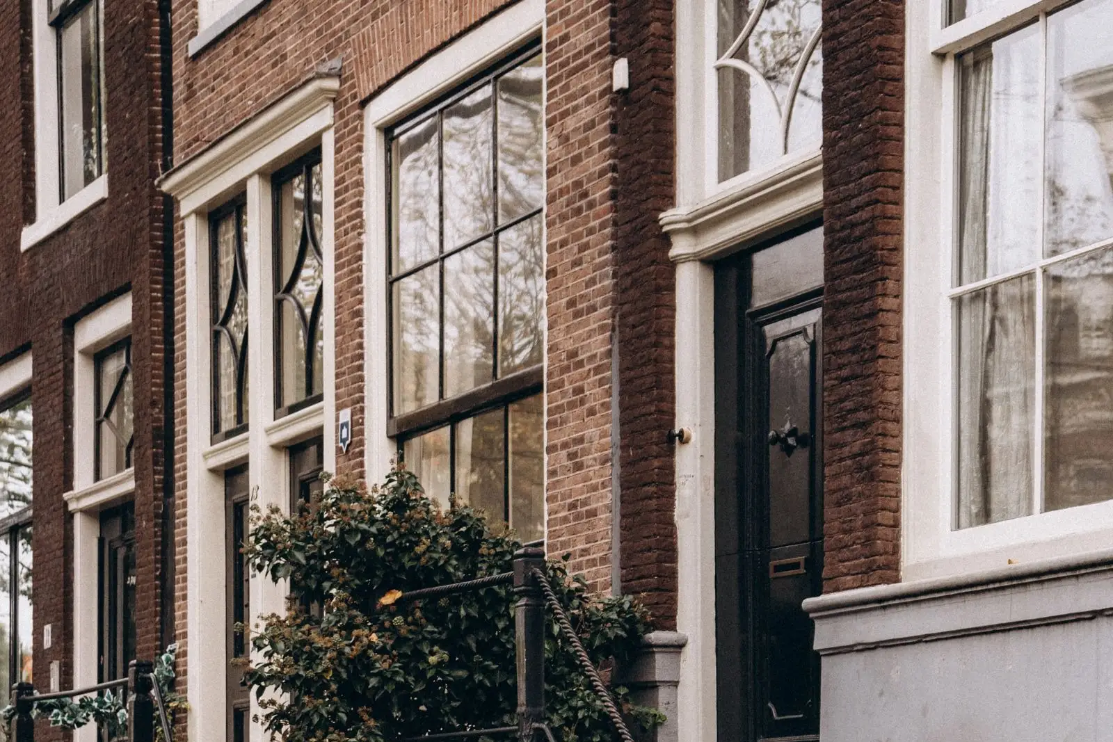 Brick and brownstone front stoops with stone treads on a residential street